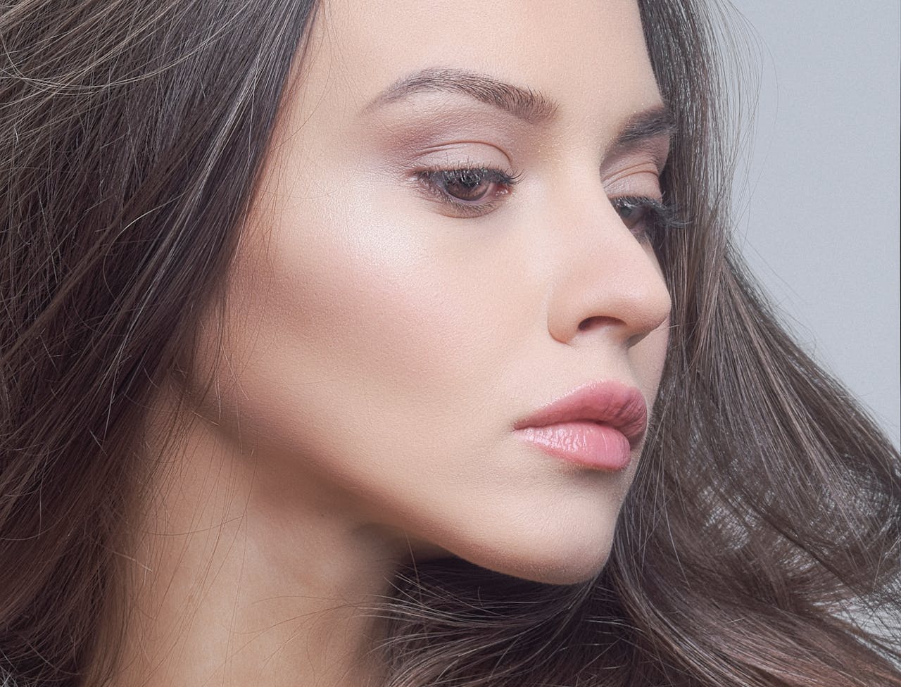 Side profile of a woman's face showcasing natural beauty and glamour.